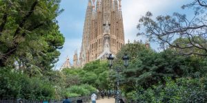 Aerial view of Sagrada Familia towers at dawn, with nearby Eixample rooftops.