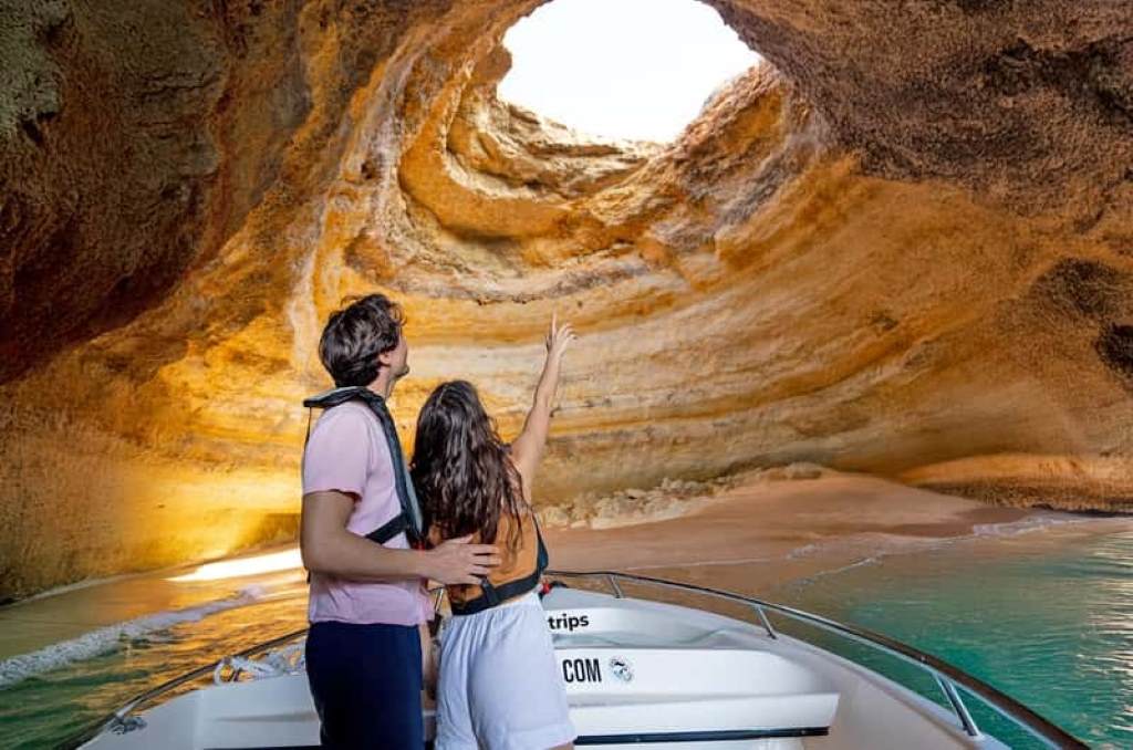Boat entering Benagil Sea Cave with natural skylight