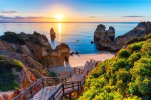 Golden cliffs and turquoise sea at Praia da Marinha in Algarve.
