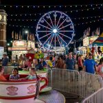 Families enjoying the midway rides and carnival attractions at the Georgia National Fair 2026 at night under the lights in Perry, Georgia