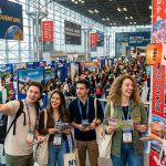 Excited travelers exploring destination booths at the New York Travel and Adventure Show 2027 in New York City